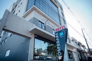 a hotel sign in front of a building at Hospedare Hotel in Marechal Cândido Rondon