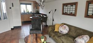 a living room with a couch and a table at Spekenbrink-Haaksbergen in Haaksbergen