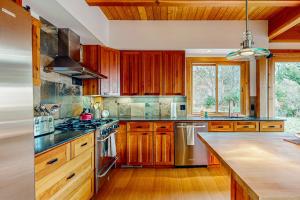 a kitchen with wooden cabinets and a stove top oven at The Barn in Gualala