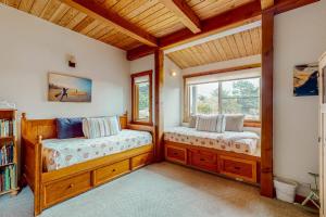 two beds in a room with two windows at The Barn in Gualala +17 photos