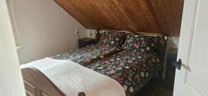 a bedroom with a bed with a comforter on it at Spekenbrink-Haaksbergen in Haaksbergen