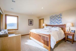 a bedroom with a large bed and a window at Ascona House in Sea Ranch