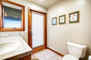 a bathroom with a toilet and a sink and a window at Ascona House in Sea Ranch +27 photos