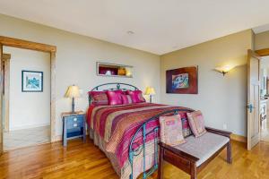 a bedroom with a bed and a bench in it at Seascape Gualala in Gualala