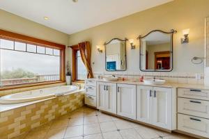 a bathroom with two sinks and a tub and a large window at Seascape Gualala in Gualala