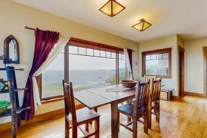 a dining room with a table and chairs and a large window at Seascape Gualala in Gualala