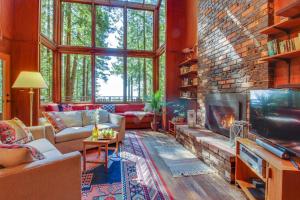 a living room with a fireplace and a brick wall at The Redwood House in Fish Rock