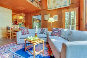 a living room with a couch and a table at The Redwood House in Fish Rock +22 photos