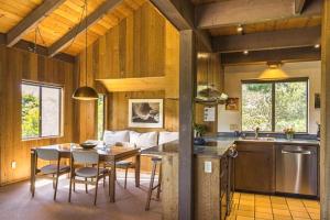 a kitchen and dining room with a table and chairs at The Glass House in Sea Ranch