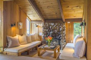 a living room with a couch and a fireplace at The Glass House in Sea Ranch +33 photos