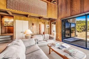 a living room with a couch and a table at The Glass House in Sea Ranch