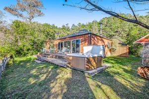 a tiny house in the grass with a gazebo at Cove House in Gualala
