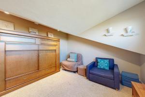 a home theater with two chairs and a large door at Eternal Equinox in Sea Ranch
