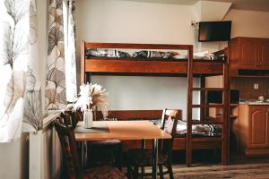 a room with a table and a bunk bed at Penzion U Kmotra in Borovany