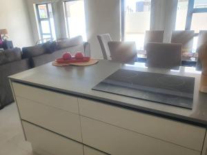 a kitchen with a counter with a table with a plate on it at Crystal Self Catering 3 bedroom Villa in Swakopmund +10 photos