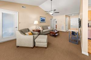 a living room with a couch and a chair at Luxury Condo with Golf Course Views Pools & Resort Access in New Bern