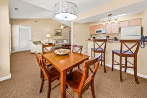 a dining room and kitchen with a table and chairs at Luxury Condo with Golf Course Views Pools & Resort Access in New Bern