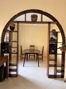 an arched dining room with a table and chairs at Akogo House - BnB , Hostel, Backpackers & Volunteer Center in Mombasa +116 photos