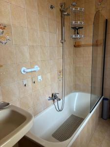 a bathroom with a shower and a tub and a sink at Casa Pianforte - appartamento per vacanze in Bolsena