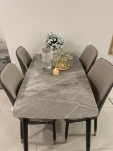 a dining room table with a gray marble table top at Homestay THAIPHONG DRAGON CASTLE Bãi Cháy in Ha Long