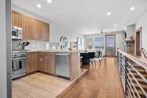 a kitchen with wooden cabinets and a counter top at Moose Ridge Hideaway Ri903 Ski Retreat Hot Tub in Eden +64 photos