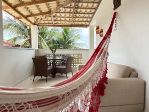 a hammock in the living room of a house at Pousada Flor do Sol in Fortaleza