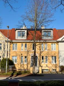 a large brick building with a red roof at YourHomeWismar in Wismar