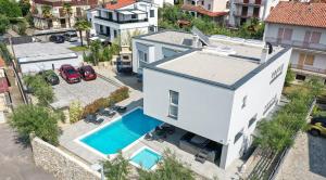 an aerial view of a house with a swimming pool at VillaLanterna in Malinska
