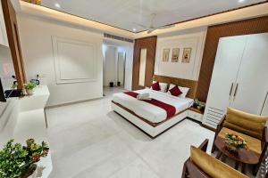 a bedroom with a bed and a couch in a room at TrueLife Nexus Suites in Tirupati