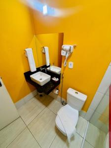 a bathroom with a white toilet and a sink at Boulevard Park Hotel in São Luís +26 photos