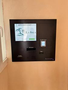 a large screen tv on the side of a wall at Hostal La Isla in Montijo