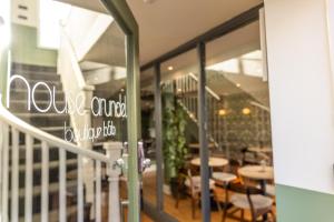 a restaurant with tables and chairs and a window at House Arundel in Arundel