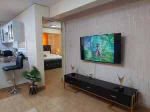a living room with a flat screen tv on the wall at Dobajo Homes2 in Kisumu