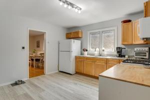 a kitchen with a white refrigerator and a table at Spacious Chicago Group Home! Walk to Train & Eats in Chicago