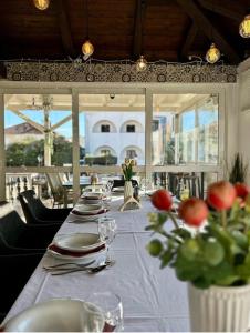 a long table with plates and glasses and flowers on it at Villa Jadro in Zadar