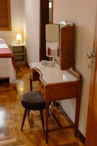 a dressing table with a mirror and a chair in a room at Casa Antunes in Diamantina +142 photos