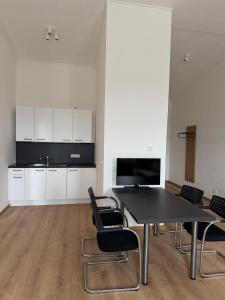 a kitchen with a table and chairs in a room at Horgau Living in Horgau