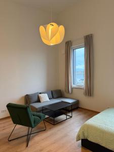 a living room with a couch and a table at Horgau Living in Horgau