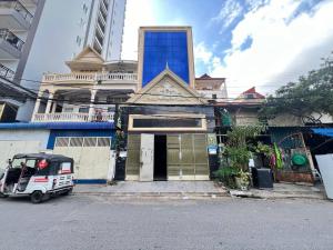 a small car parked in front of a building at Arecrata in Phnom Penh
