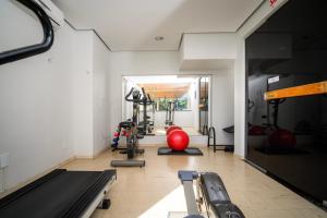 a gym with treadmills and exercise equipment in a room at Brivali Hotel Centro in Caçador