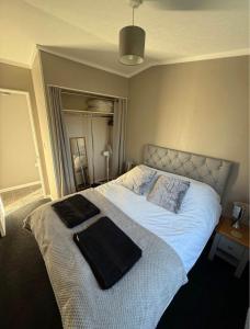 a bedroom with a bed with two towels on it at Two Bedroom Lodge in Gainsborough
