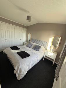 a bedroom with a large bed and a tv at Two Bedroom Lodge in Gainsborough