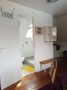 a living room with a table and a bathroom at VERYAC'H in Camaret-sur-Mer