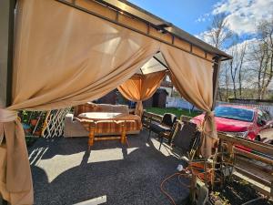 a patio with a tent and a table and chairs at Cudowne poddasze in Piotrków Trybunalski