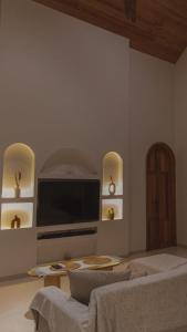 a living room with a tv and a couch at Green Waves Villa in Batukaras