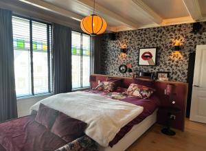 a bedroom with a large bed in a room at Boutique Home in Maassluis