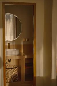 a bathroom with a sink and a mirror at Green Waves Villa in Batukaras +30 photos