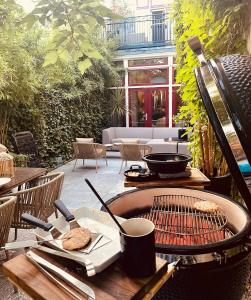 an outdoor table with a grill on a patio at Boutique Home in Maassluis