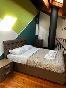 a bedroom with a bed with a green and blue wall at Appartamento Il Loftino in Forlì