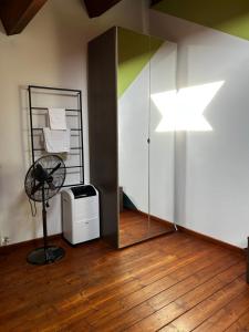a room with a fan and a star on the wall at Appartamento Il Loftino in Forlì +49 photos